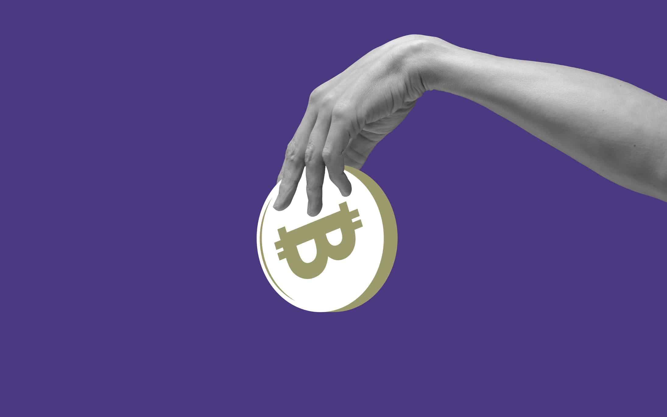 Hand holding bitcoin